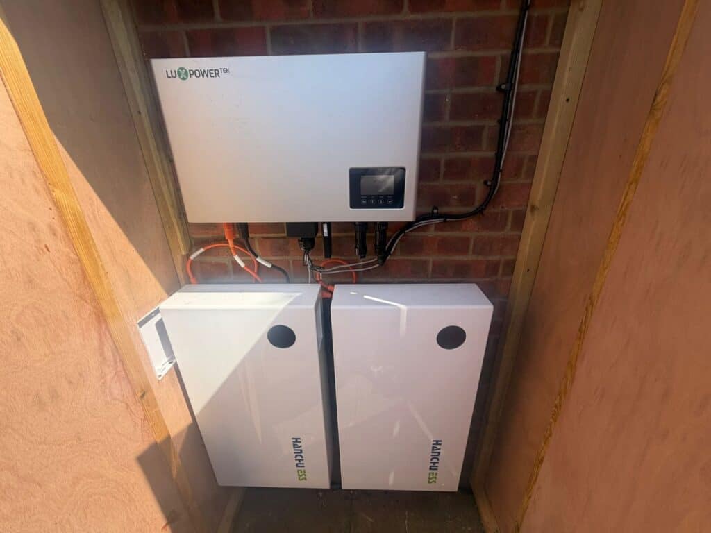 Hybrid inverter and two battery units fitted in a wooden enclosure