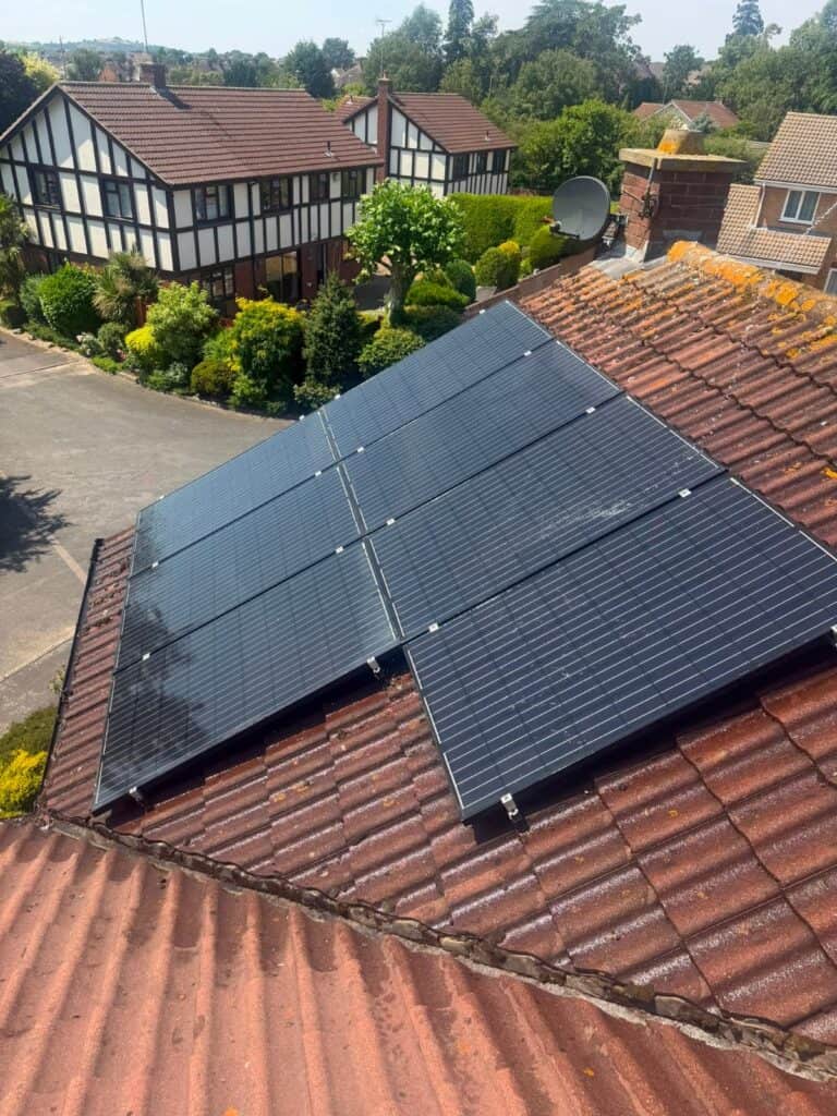Black solar panels on a red tiled roof