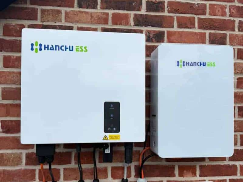 Hybrid solar inverter and wall-mounted battery installed on a brick wall in Sheffield
